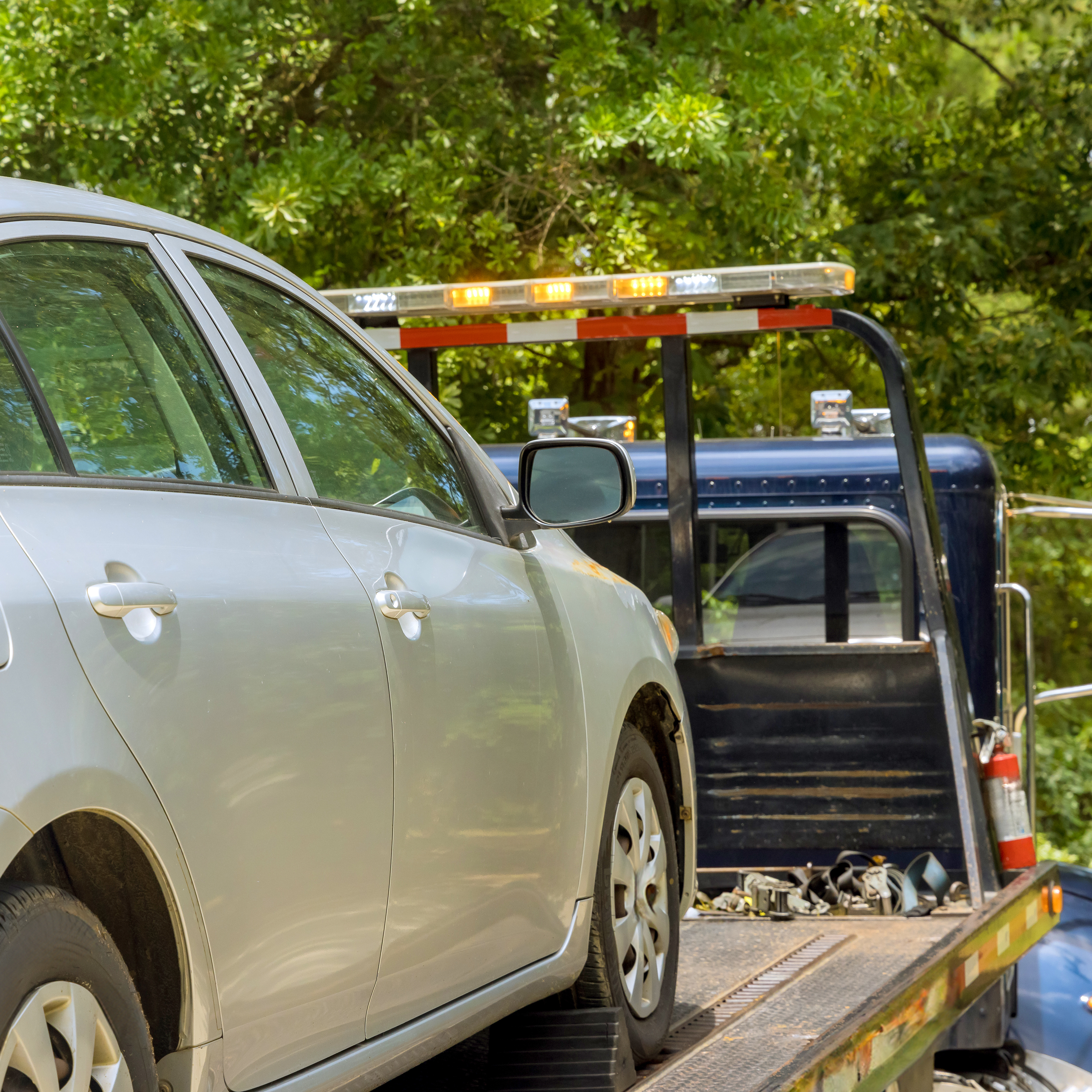 Tow truck collecting an unwanted car for cash