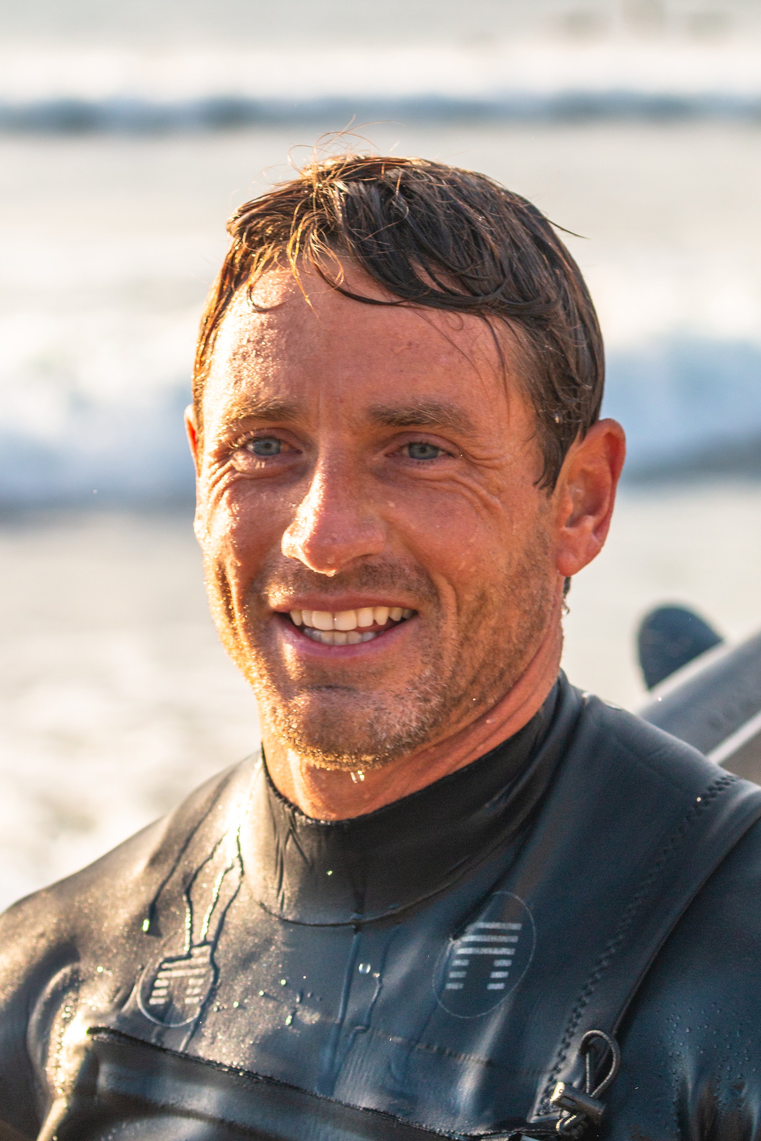 A person surfing a wave with elegant technique in morning light, a surfboard, and ocean spray, with a clean, modern filter and a shallow depth of field.