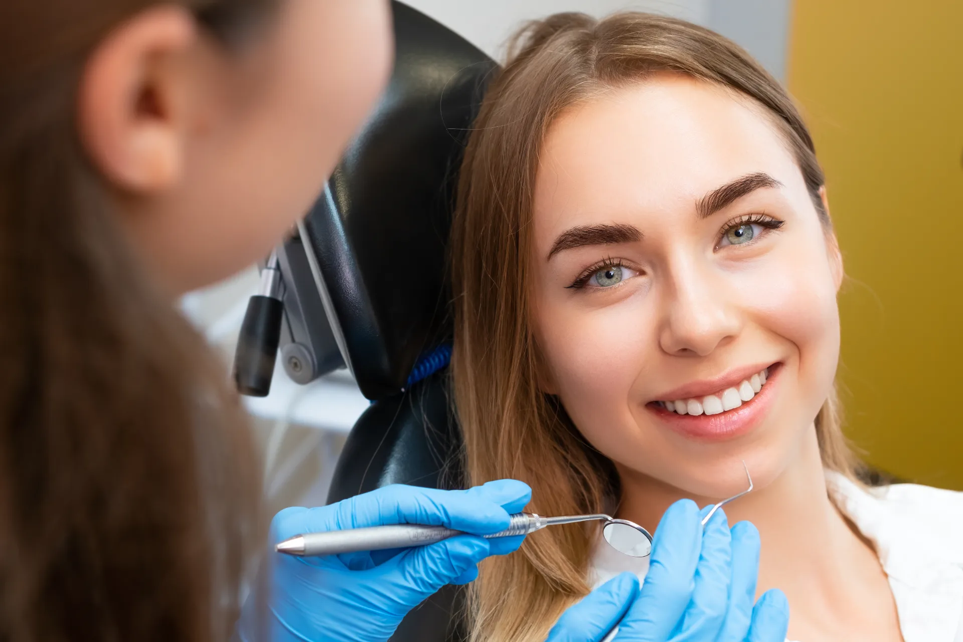 Dentist delivering cosmetic dental treatment