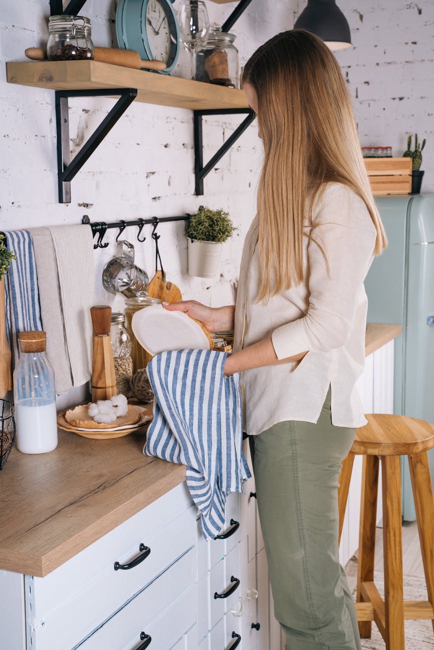 Professional cleaner using eco-friendly products on a kitchen counter